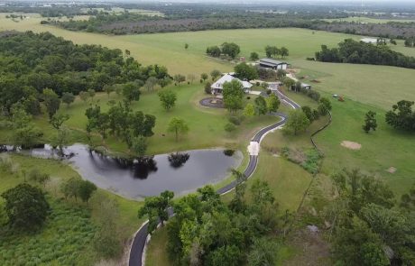 country house with long paved and seal coated driveway.