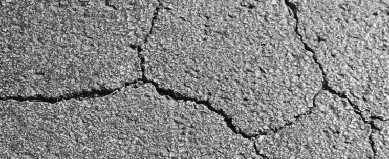 A cracked asphalt driveway.