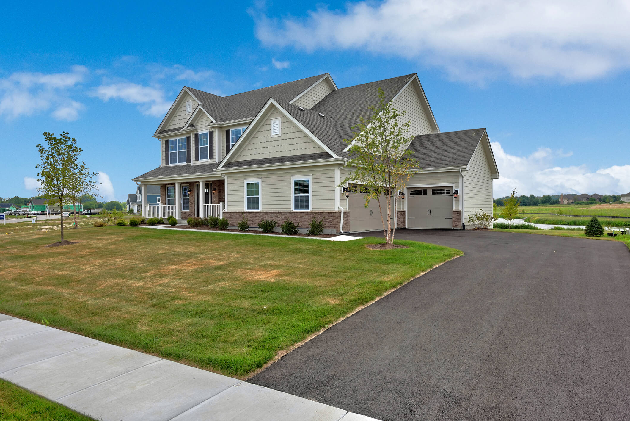 A residential home with a freshly paved driveway.